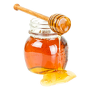 Honey dipper and honeycomb with honey on a wooden surface